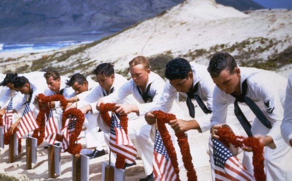 Navy members put leis on the
